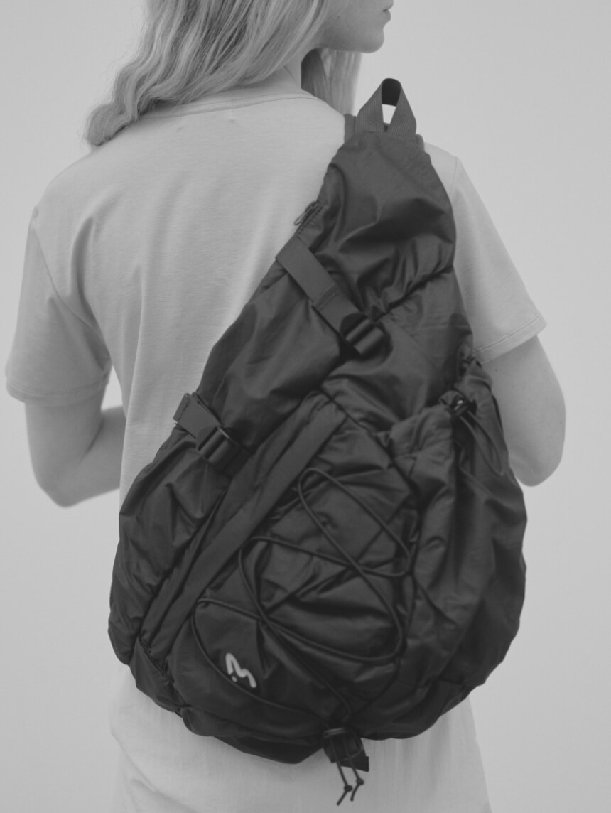 ワンショルダーボディーバッグを背負った女性モデルの画像